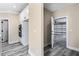 Mud room access to garage with built in oven and microwave adjacent to modern gray wood floors at 4285 Haynes Cir, Snellville, GA 30039