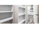 Walk-in pantry with built-in shelving next to the kitchen at 4285 Haynes Cir, Snellville, GA 30039