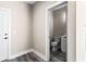Convenient powder room with toilet and vanity located on main level with gray wood floors at 4285 Haynes Cir, Snellville, GA 30039
