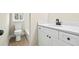 Beautiful bathroom with tile floors, modern vanity and toilet next to a window at 75 Woodfield Rd, Covington, GA 30014