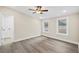 Freshly painted bedroom with ceiling fan and sleek floors with natural light and door to hall at 75 Woodfield Rd, Covington, GA 30014