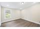 Bedroom with neutral paint and modern flooring with a window that looks out to the yard at 75 Woodfield Rd, Covington, GA 30014