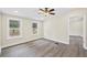 Freshly painted bedroom with ceiling fan and sleek floors with natural light from two windows at 75 Woodfield Rd, Covington, GA 30014