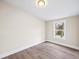 A clean, well-lit bedroom features durable, gray wood-look flooring and fresh neutral paint at 75 Woodfield Rd, Covington, GA 30014