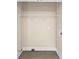 Empty closet space with wire shelving and utility connections, ready for customization at 75 Woodfield Rd, Covington, GA 30014