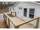 Inviting home entrance featuring a wooden deck, stylish lighting, and fresh white paint at 75 Woodfield Rd, Covington, GA 30014