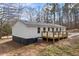 Rear view of a cozy single-story home featuring a wooden deck and a freshly painted exterior at 75 Woodfield Rd, Covington, GA 30014