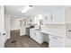 Kitchen with stainless steel appliances, white cabinets, and a view into the living area at 75 Woodfield Rd, Covington, GA 30014