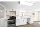Bright white kitchen featuring modern appliances, cabinets, countertops, and stylish flooring at 75 Woodfield Rd, Covington, GA 30014