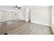 Open concept living room with neutral paint, new flooring, and ceiling fan at 75 Woodfield Rd, Covington, GA 30014