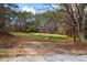 Expansive view of the home's large grassy lot surrounded by mature trees at 75 Woodfield Rd, Covington, GA 30014