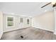 Well-lit room featuring two windows, a ceiling fan, and a door leading to the exterior at 75 Woodfield Rd, Covington, GA 30014