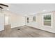 Bright room with multiple windows and an exterior door, featuring wood-look flooring at 75 Woodfield Rd, Covington, GA 30014