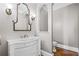 Elegant powder room with a marble countertop vanity, decorative mirror, and modern fixtures at 101 Gold Leaf Ct, Canton, GA 30114