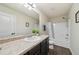 Bathroom with a granite countertop vanity, with tub and shower, toilet, and white wooden door at 104 Amelia Way, Ellenwood, GA 30294