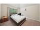 A bedroom featuring a bed and desk by the window, with neutral carpeting and soft natural light at 104 Amelia Way, Ellenwood, GA 30294
