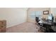 Office bedroom features a window, dark-colored desk, and carpet, ideal for a study or workspace at 104 Amelia Way, Ellenwood, GA 30294