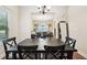Dining area featuring hardwood floors, modern table set, and natural light creating a welcoming space at 104 Amelia Way, Ellenwood, GA 30294