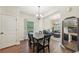 Dining room with hardwood floors, natural light, and seating for six with easy access to living area at 104 Amelia Way, Ellenwood, GA 30294