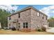 This home features a brick exterior, attached garage, and outdoor patio seating area at 104 Amelia Way, Ellenwood, GA 30294
