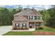 Beautiful two-story brick home featuring manicured lawn, complementing landscaping and inviting entrance at 104 Amelia Way, Ellenwood, GA 30294