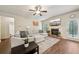 Comfortable living room with fireplace, ceiling fan, and hardwood floors, perfect for relaxation at 104 Amelia Way, Ellenwood, GA 30294