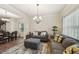 Inviting living room featuring hardwood floors, and gray couches with yellow and gray pillows at 104 Amelia Way, Ellenwood, GA 30294