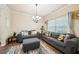 Comfortable living room showcasing two couches, ottoman, and a large window with natural light at 104 Amelia Way, Ellenwood, GA 30294