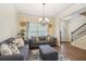 Living room with an open concept, features stylish furniture and light-filled space at 104 Amelia Way, Ellenwood, GA 30294