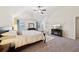 Cozy main bedroom with natural light, a ceiling fan and a fireplace at 104 Amelia Way, Ellenwood, GA 30294
