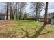 Expansive backyard featuring a well-manicured lawn and mature trees at 1495 Longwood Sw Dr, Marietta, GA 30008