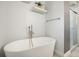Bright bathroom featuring a modern soaking tub and glass enclosed shower at 1495 Longwood Sw Dr, Marietta, GA 30008