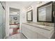 Bright bathroom featuring a double vanity with granite countertops and tile flooring at 1495 Longwood Sw Dr, Marietta, GA 30008