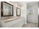 Bright bathroom featuring a double vanity with granite countertops and tile flooring at 1495 Longwood Sw Dr, Marietta, GA 30008