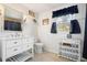 Bright bathroom featuring a classic vanity, window, and matching decor at 1495 Longwood Sw Dr, Marietta, GA 30008
