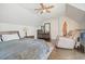 Bright bedroom featuring a ceiling fan, dark wood floors, and a recliner at 1495 Longwood Sw Dr, Marietta, GA 30008