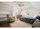 Bright bedroom featuring a ceiling fan, dark wood floors, and a recliner at 1495 Longwood Sw Dr, Marietta, GA 30008