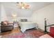 Cozy bedroom featuring a ceiling fan, hardwood floors, and a comfortable sitting area at 1495 Longwood Sw Dr, Marietta, GA 30008