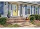 Closeup of front entrance, featuring yellow door with brick steps and blue shutters at 1495 Longwood Sw Dr, Marietta, GA 30008