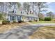 Charming single Gathering home featuring a yellow front door, blue shutters, and well maintained lawn at 1495 Longwood Sw Dr, Marietta, GA 30008