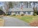 Charming single Gathering home featuring a yellow front door, blue shutters, and well maintained lawn at 1495 Longwood Sw Dr, Marietta, GA 30008