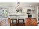 Bright kitchen featuring stainless appliances, white cabinetry, an island, and hardwood floors at 1495 Longwood Sw Dr, Marietta, GA 30008