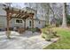 Charming patio with a pergola, offering an ideal outdoor living space with landscaping at 1495 Longwood Sw Dr, Marietta, GA 30008