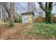 Backyard shed with a yellow door, surrounded by greenery and offering storage space at 1495 Longwood Sw Dr, Marietta, GA 30008