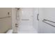 Bathroom featuring a clean white tub and shower with accessibility grab bars and shelving at 1800 Clairmont Lk # A719, Decatur, GA 30033