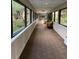Bright hallway featuring large windows with views of lush greenery and outdoor seating at 1800 Clairmont Lk # A719, Decatur, GA 30033