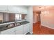 Well-lit kitchen features white cabinets, a stainless steel sink, and tiled backsplash that adds a modern touch at 1800 Clairmont Lk # A719, Decatur, GA 30033