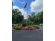 Beautifully landscaped roundabout with vibrant flowers and an American flag, creating an attractive welcome at 1800 Clairmont Lk # A719, Decatur, GA 30033
