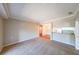 Spacious living room with plush carpet and a kitchen with white appliances and a bar, perfect for entertaining at 1800 Clairmont Lk # A719, Decatur, GA 30033