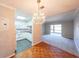 Bright living room featuring a decorative chandelier, plush carpeting and an attached kitchen with white cabinets at 1800 Clairmont Lk # A719, Decatur, GA 30033